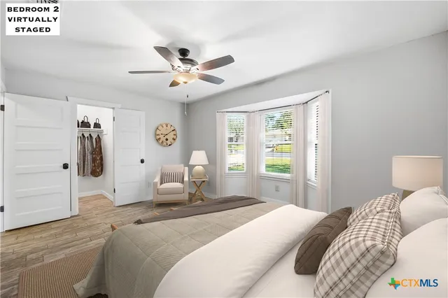 a bedroom with a bed and a window