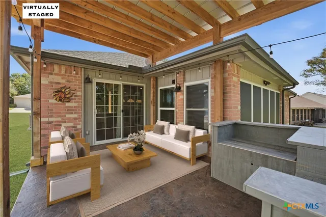 a balcony with furniture and a potted plant