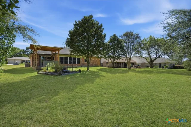 a view of house with a big yard