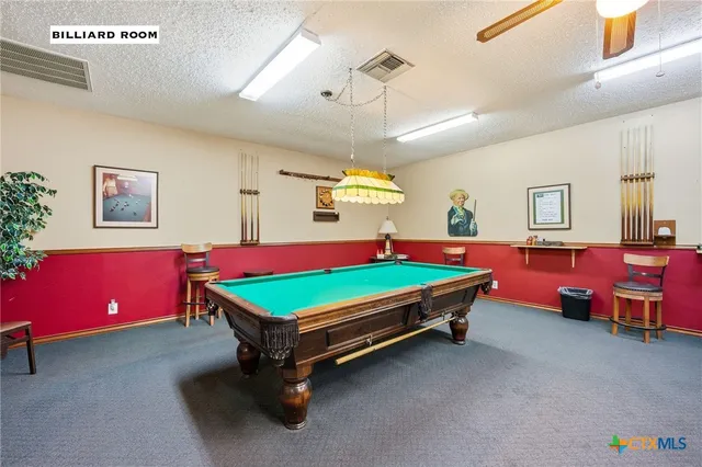 a room with pool tables and windows