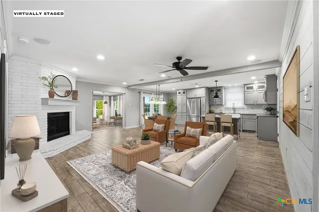 a living room with furniture fireplace and flat screen tv