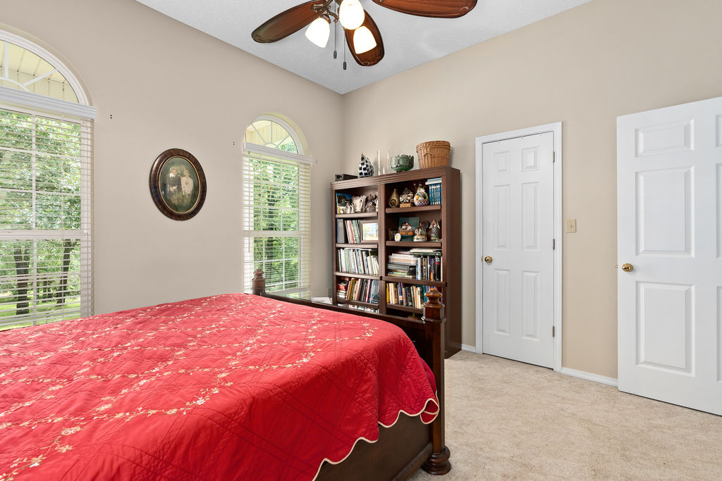 365 Calihan Road Booneville, AR 72927 - Photo 35 of 59 Room featuring two arched windows with horizontal blinds, a ceiling fan with integrated lighting, and neutral-toned wall paint