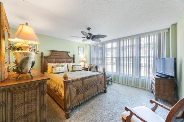 a bed room with a bed and a television