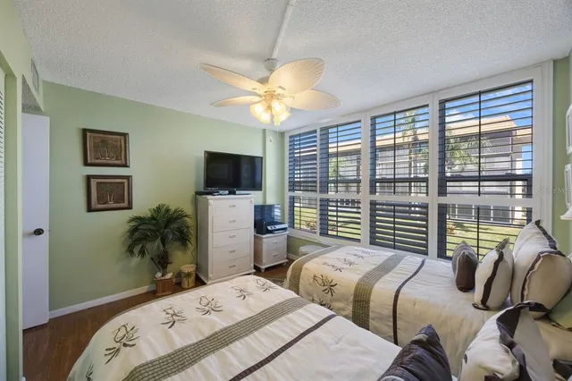 a bedroom with two beds and a large window