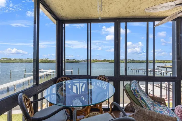 a view of a porch with furniture and floor to ceiling windows