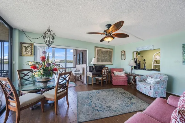 a living room with furniture chandelier and a window