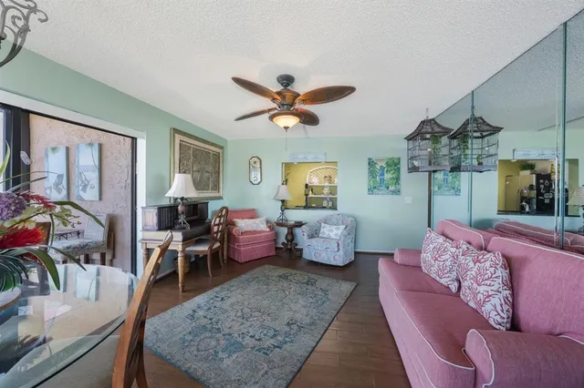 a living room with furniture ceiling fan and a rug