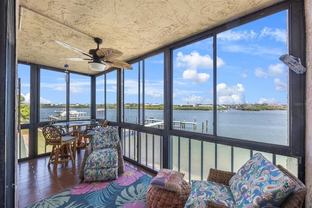 a living room with furniture and a floor to ceiling window