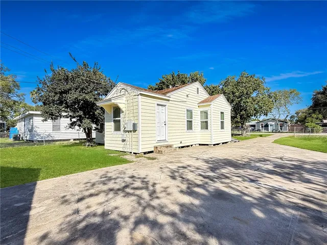 a front view of a house with a garden and yard