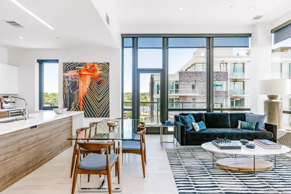 a living room with furniture and a floor to ceiling window