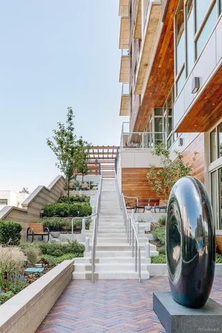 a view of a balcony with two chairs and a potted plant