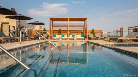 a swimming pool view with a outdoor seating space