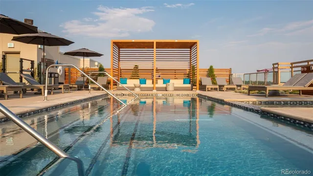 a swimming pool view with a outdoor seating space