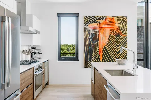 a kitchen with stainless steel appliances granite countertop a sink and a stove