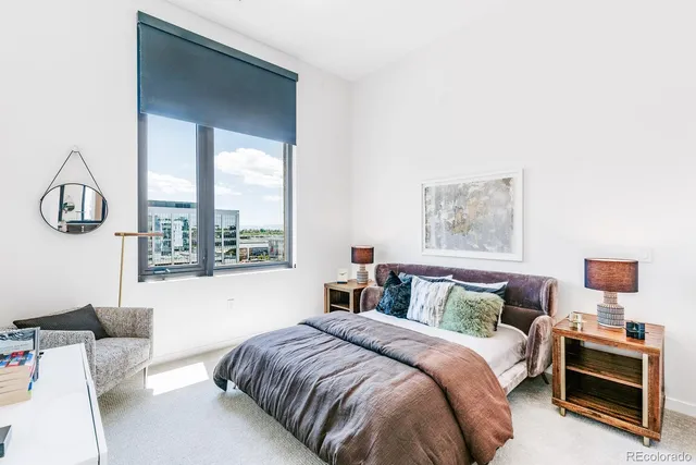 a bedroom with a bed a couch and dresser