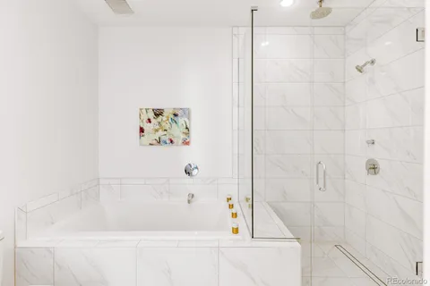 a bathroom with a bathtub and a shower