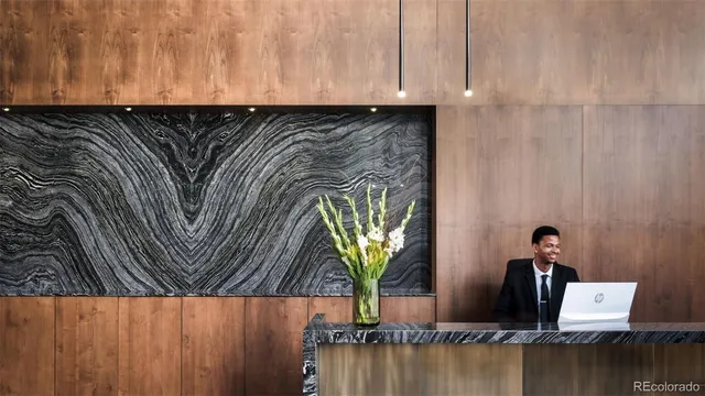 a view of a sink with a cabinet and a potted plant in front of it
