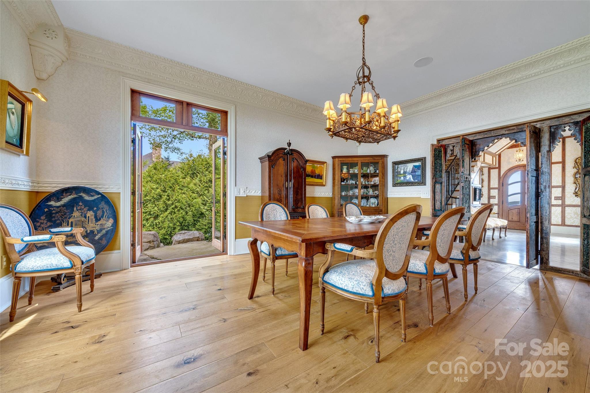 278 North Snow Ridge Drive Fairview, NC 28730 - Photo 13 of 48 a dining room with furniture a chandelier and wooden floor