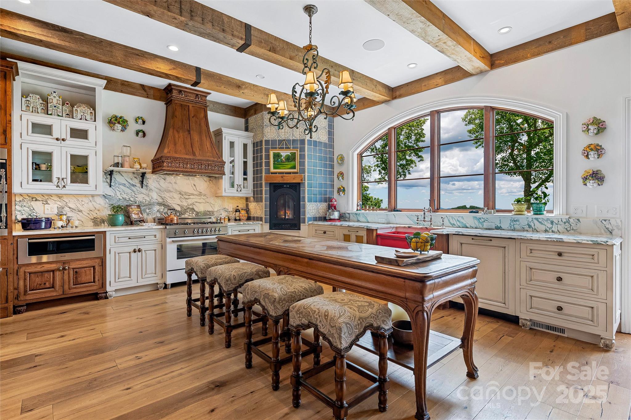 278 North Snow Ridge Drive Fairview, NC 28730 - Photo 16 of 48 a kitchen with a stove a sink dishwasher a dining table and chairs with wooden floor