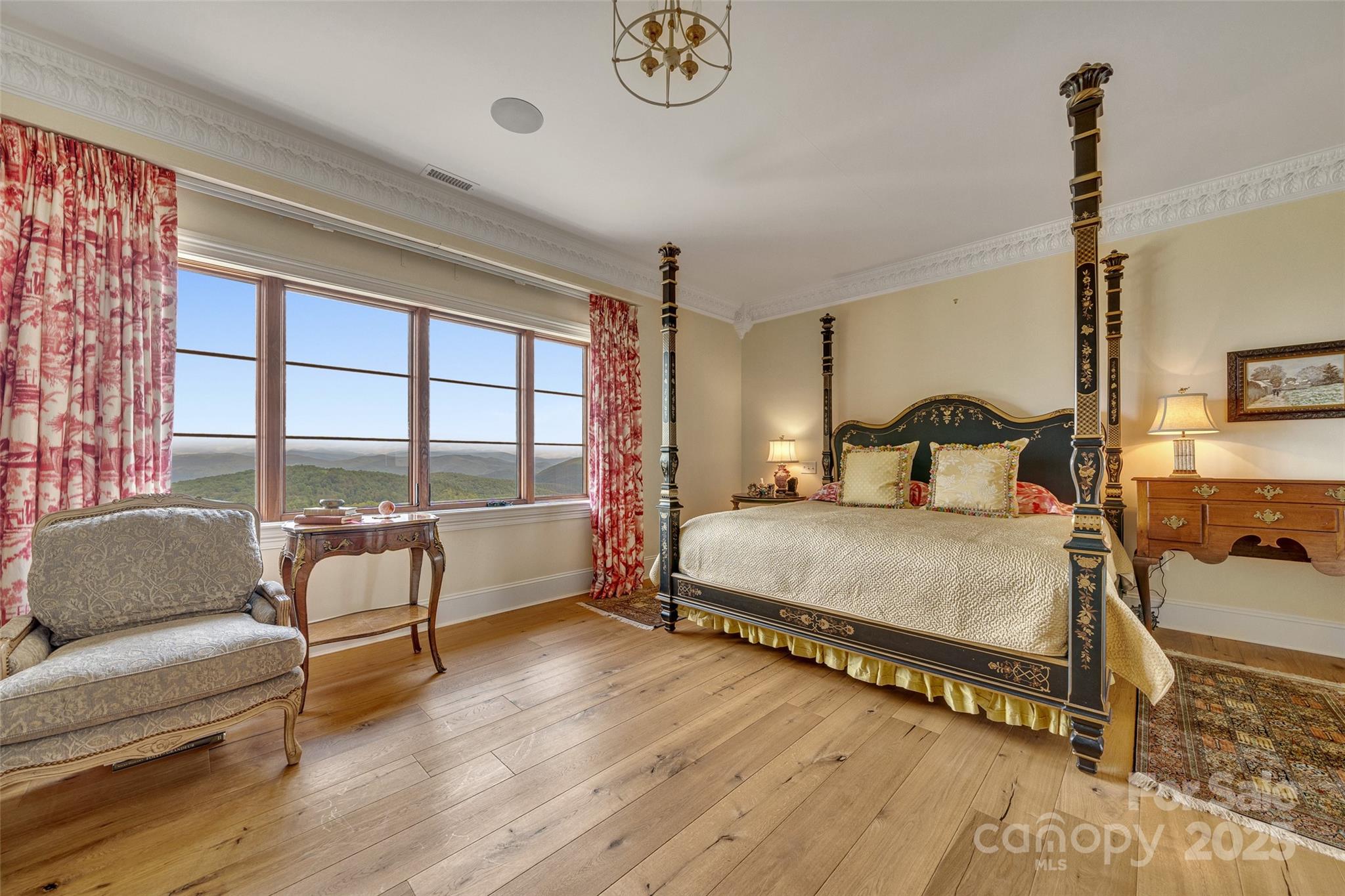 278 North Snow Ridge Drive Fairview, NC 28730 - Photo 25 of 48 a bedroom with a bed a couch and a window with wooden floor