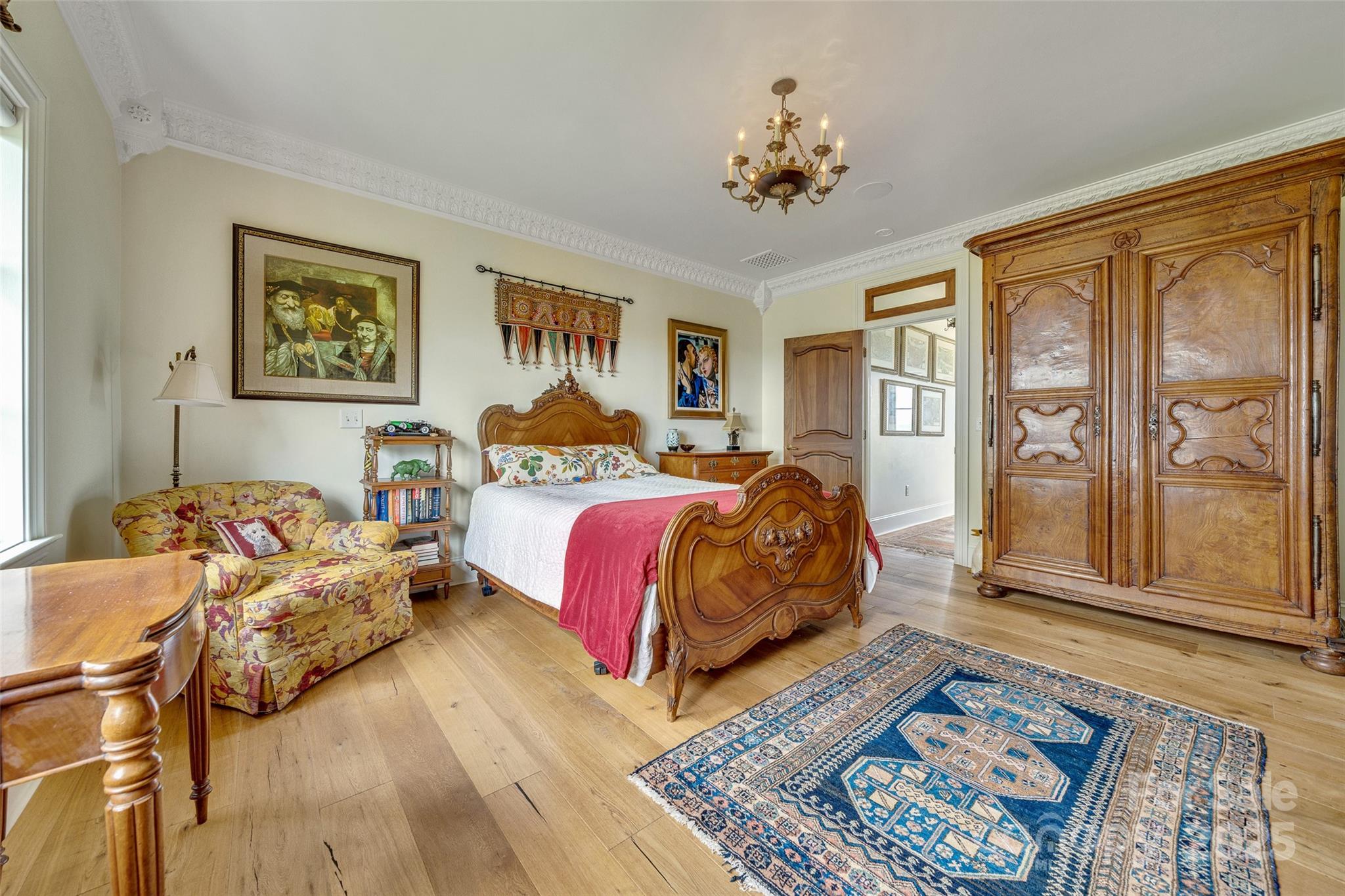 278 North Snow Ridge Drive Fairview, NC 28730 - Photo 29 of 48 a spacious bedroom with a bed a dresser and windows