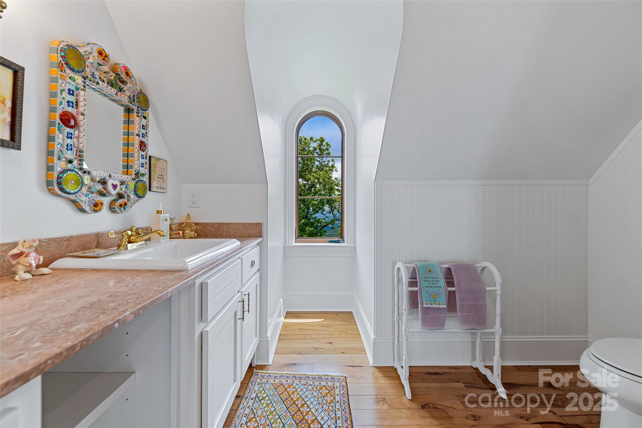 278 North Snow Ridge Drive Fairview, NC 28730 - Photo 35 of 48 a bathroom with a granite countertop sink a toilet and a window