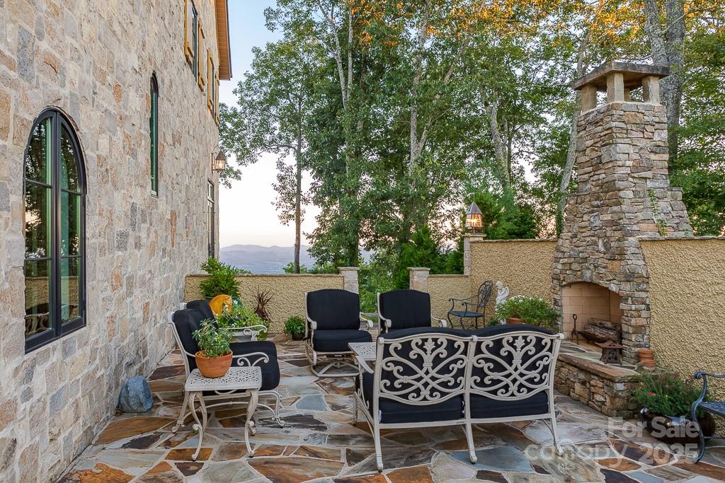 278 North Snow Ridge Drive Fairview, NC 28730 - Photo 40 of 48 a view of a patio with table and chairs and potted plants
