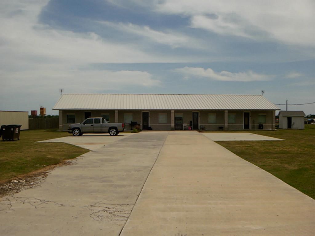 6500 South Fm 565 Rd Cove Cove, TX 77523 - Photo 2 of 8 a view of building with car parked