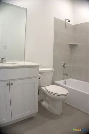 a bathroom with a toilet a sink and bathtub