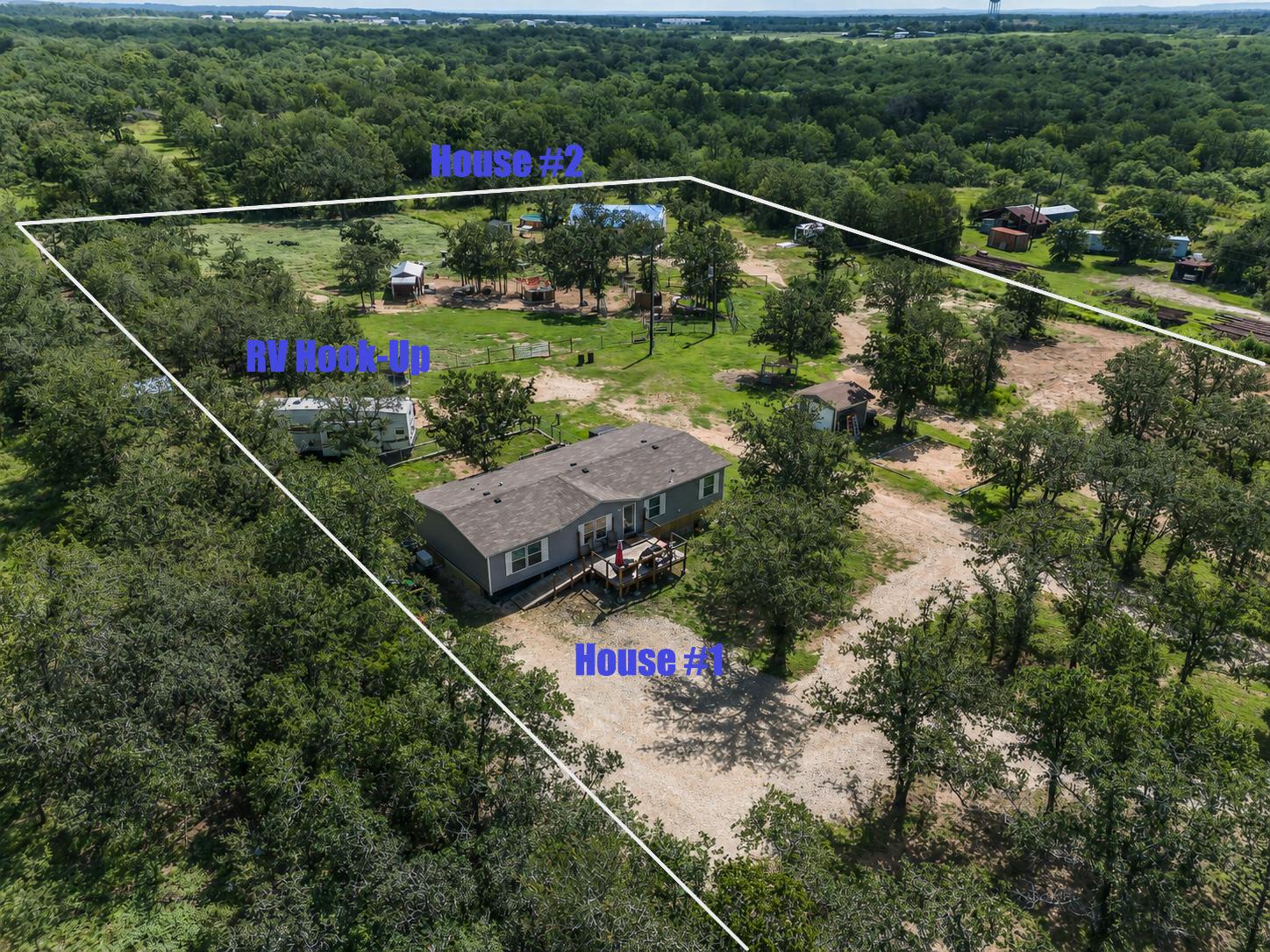 2755 Washburn Road Luling, TX 78648 - Photo 1 of 40 Discover a private, wooded estate with multiple residences and an RV hook-up.