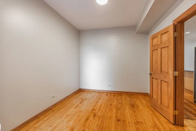 a view of a room with wooden floor and brick walls