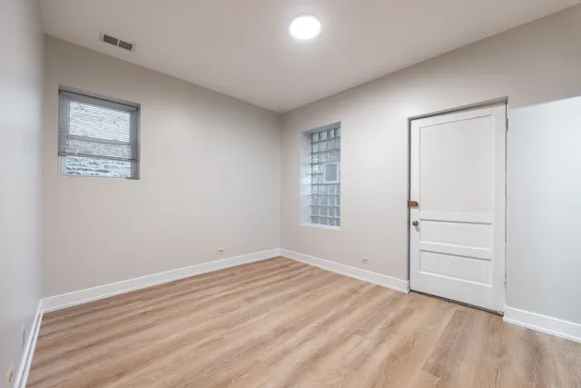 an empty room with windows and closet