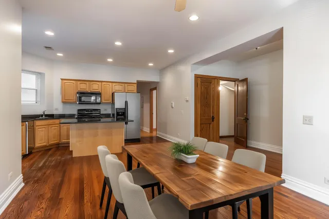 a kitchen with a table chairs sink and cabinets