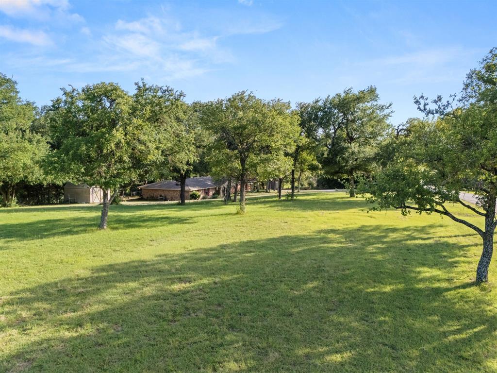 13539 Chapel Road Lorena, TX 76655 - Photo 28 of 37 Expansive lawn with mature trees, offering a broad green space