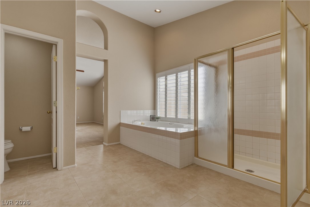 29 Olive Tree Henderson, NV 89074 - Photo 33 of 60 This spacious bathroom offers a relaxing soaking tub and a convenient walk-in shower.