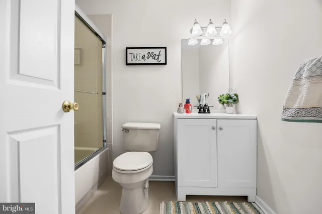 a bathroom with a toilet a sink and a mirror