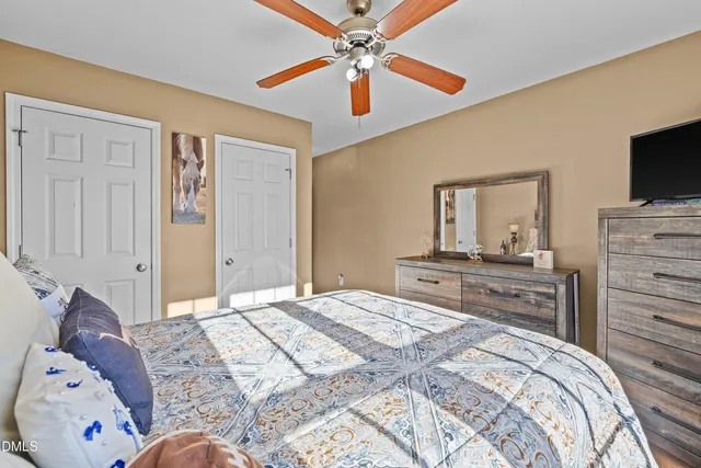 a bedroom with a large bed and a flat screen tv