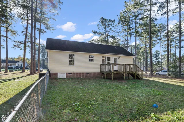 a view of a house with a yard and sitting area