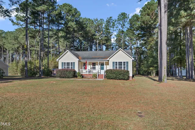 a front view of house with yard and green space