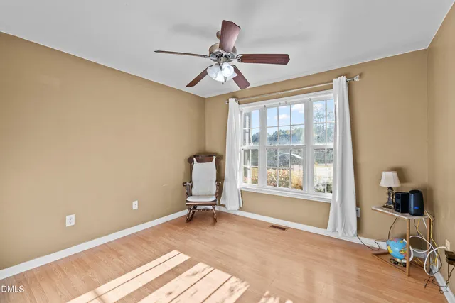 a view of a livingroom with a window and a ceiling fan