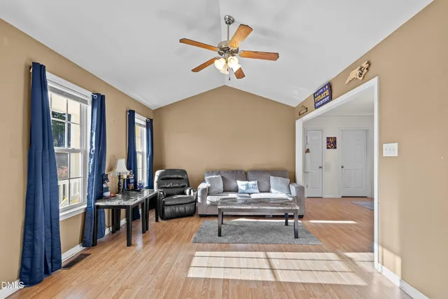 a living room with furniture and wooden floor