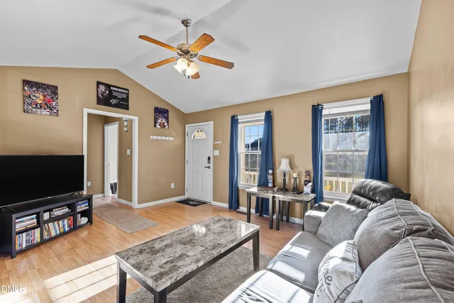 a living room with furniture and a flat screen tv