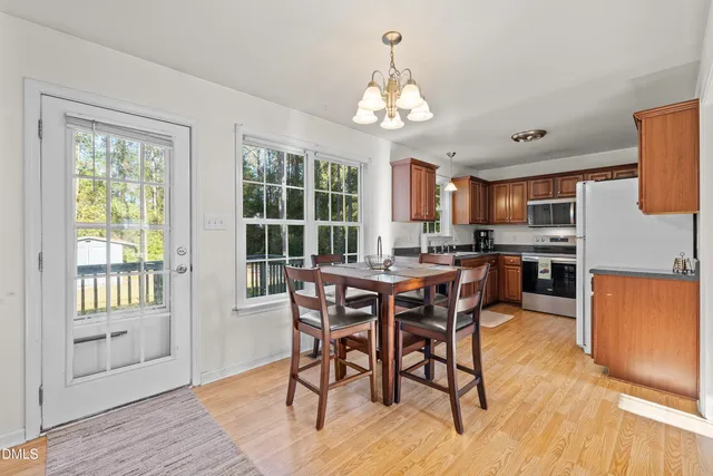 a view of a dining room with furniture window and wooden floor