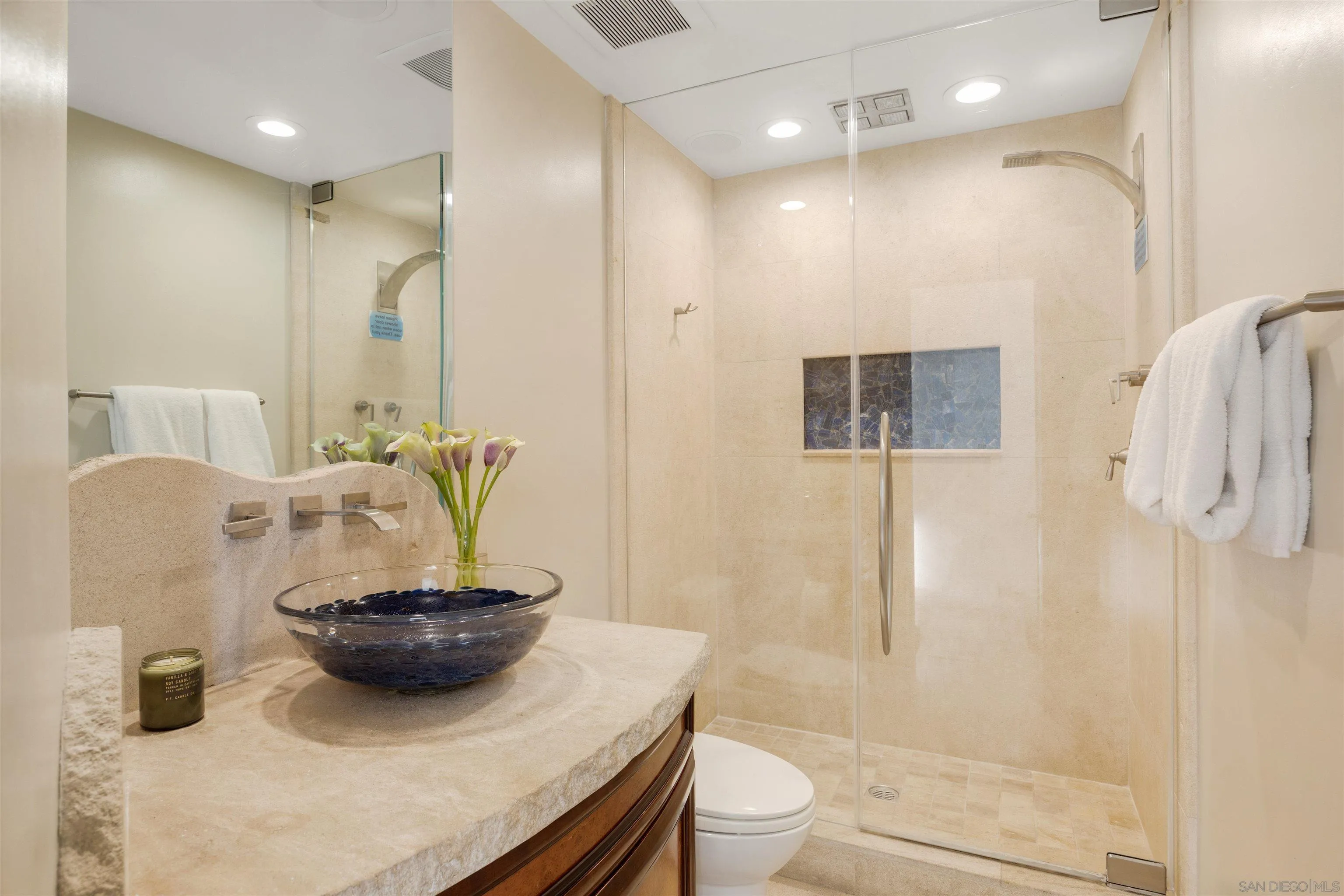 3921 Ocean Front Walk San Diego, CA 92109 - Photo 27 of 32 a bathroom with a granite countertop sink a toilet and shower
