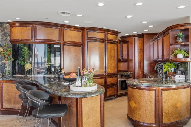 a dining table with chairs and potted plant