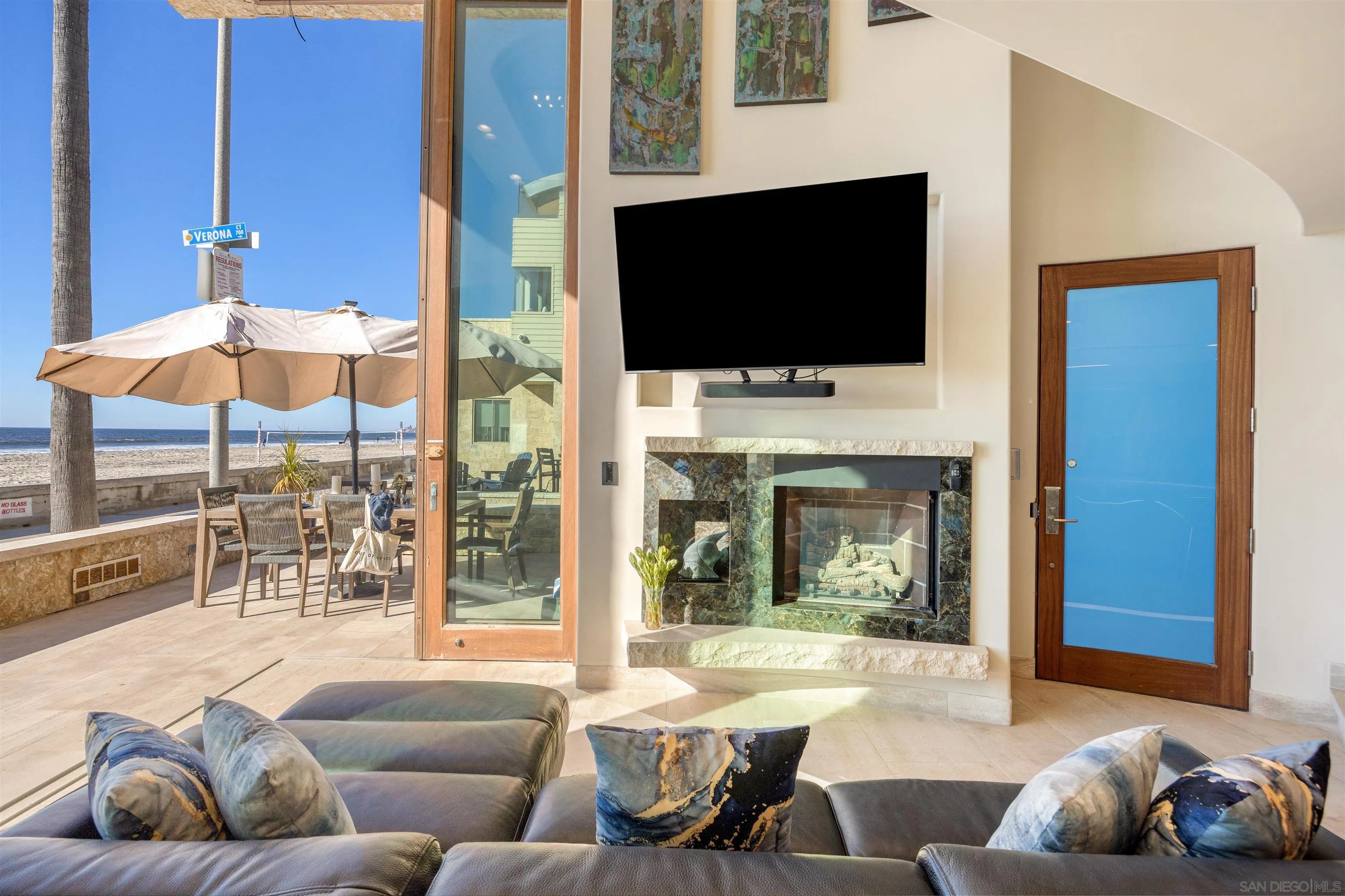 3921 Ocean Front Walk San Diego, CA 92109 - Photo 6 of 32 a living room with furniture a flat screen tv and a fireplace