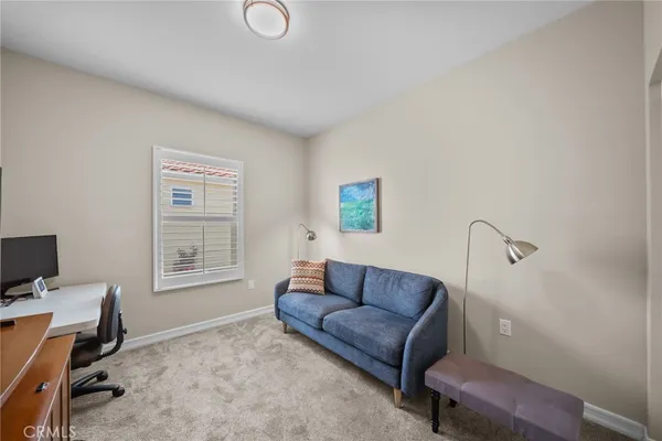 a living room with furniture a couch and a window