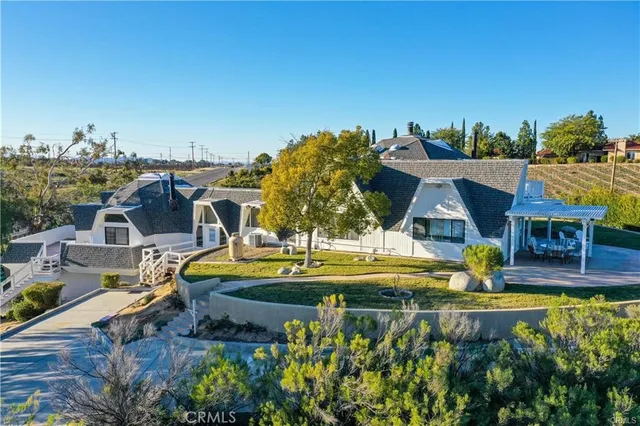 an aerial view of a house with swimming pool garden and patio