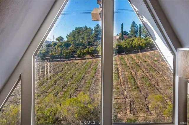 a bedroom with a bed and large windows
