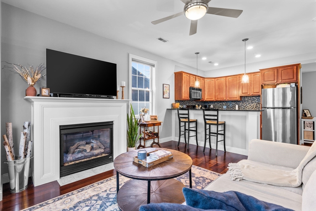 34 H Street, Unit 2L Boston, MA 02127 - Photo 2 of 20 a living room with furniture a fireplace and a flat screen tv